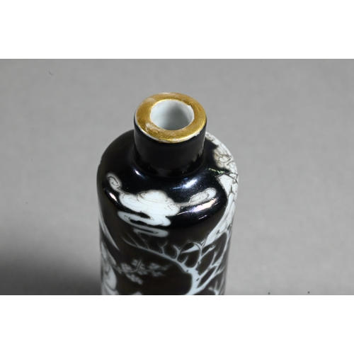 515 - A 19th century Chinese black ground en-grisaille porcelain snuff bottle of high shouldered cylindric... 