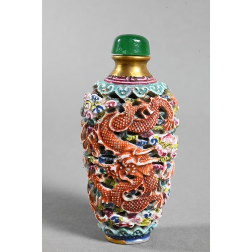 516 - A Chinese moulded porcelain famille rose snuff bottle with green glass stopper, modelled with a sinu... 