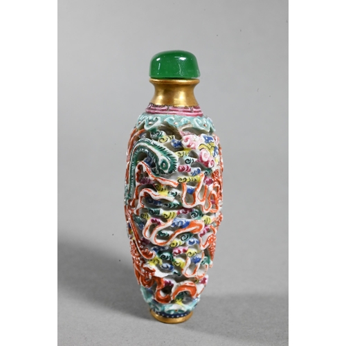 516 - A Chinese moulded porcelain famille rose snuff bottle with green glass stopper, modelled with a sinu... 