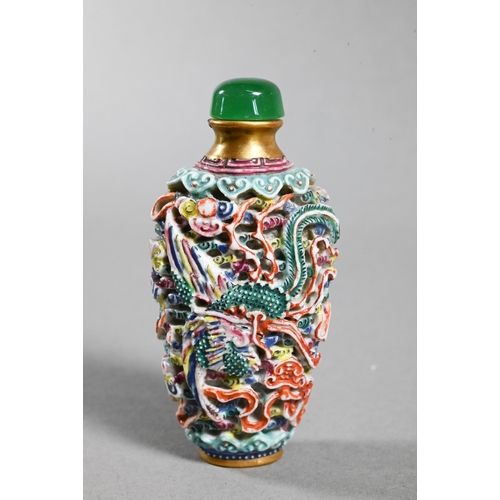 516 - A Chinese moulded porcelain famille rose snuff bottle with green glass stopper, modelled with a sinu... 