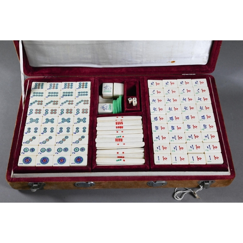 519 - A vintage Chinese velvet cased Mah-Jong set with bone and bamboo tiles including three complete suit... 