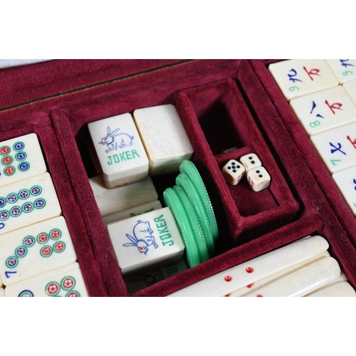 519 - A vintage Chinese velvet cased Mah-Jong set with bone and bamboo tiles including three complete suit... 