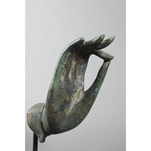 529 - An antiqued Thai mounted bronze 'hand of Buddha' cast in vitarka-mudra (Buddhist teaching or discuss... 