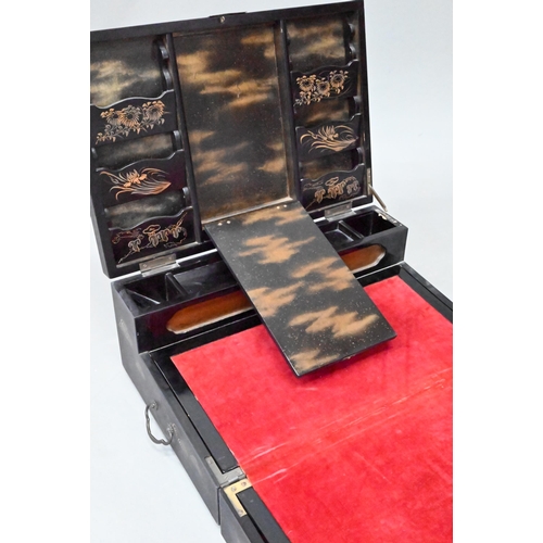 530 - An early 20th century Japanese black lacquered brass mounted writing box with twin hinged top and fi... 