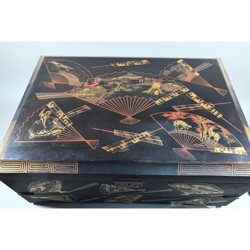 530 - An early 20th century Japanese black lacquered brass mounted writing box with twin hinged top and fi... 