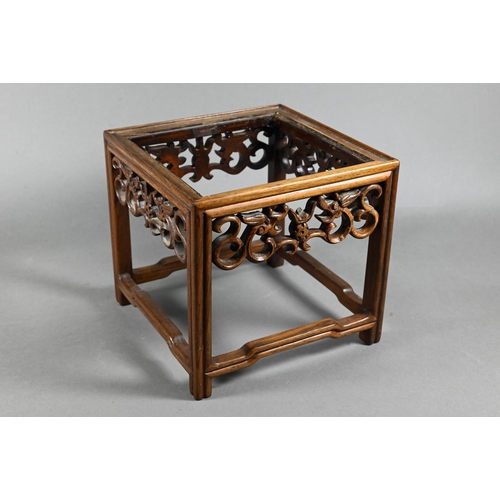 538 - A late 19th or early 20th century Chinese square stand (lacking top panel) with carved and pierced d... 