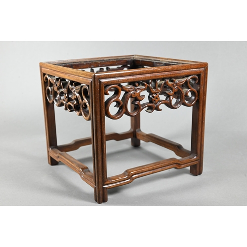 538 - A late 19th or early 20th century Chinese square stand (lacking top panel) with carved and pierced d... 