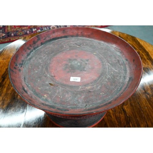 539 - An early 20th century Burmese red and black lacquer circular tray on attached stick-spindle stand (K... 