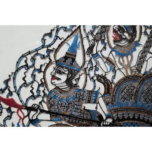 548 - Two Thai cut-out buffalo or cow hide Nang Talung poychrome shadow puppets, mounted framed and glazed... 