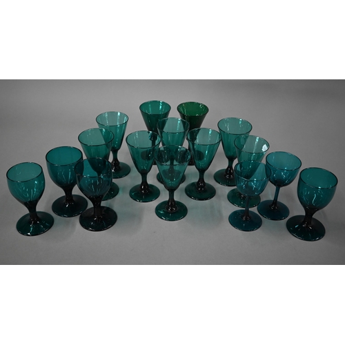 559 - A set of eight 19th century green wine glasses with conical bowls, baluster stems and ground-out pon... 