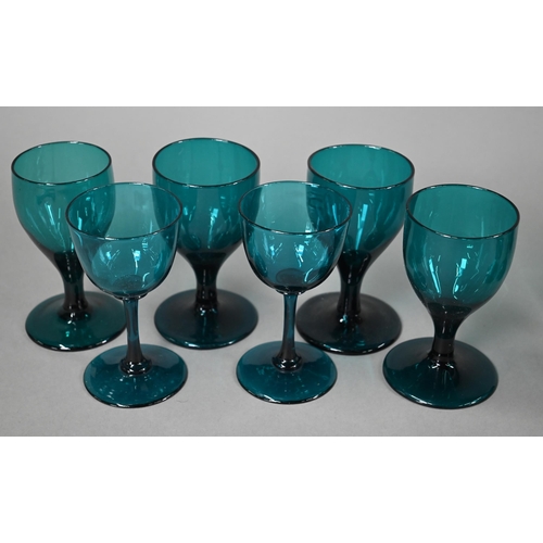 559 - A set of eight 19th century green wine glasses with conical bowls, baluster stems and ground-out pon... 