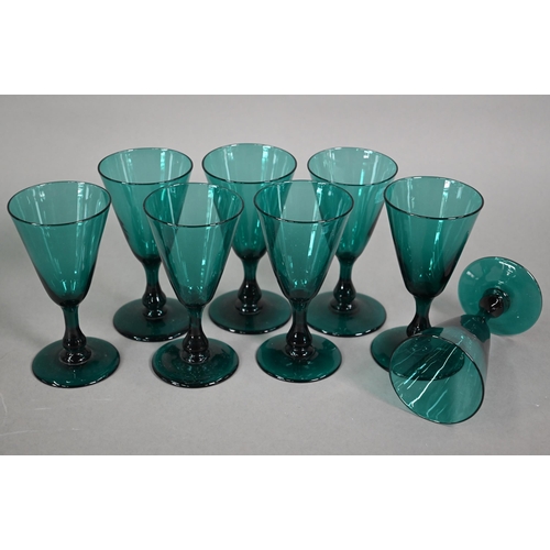 559 - A set of eight 19th century green wine glasses with conical bowls, baluster stems and ground-out pon... 