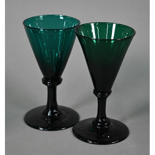 559 - A set of eight 19th century green wine glasses with conical bowls, baluster stems and ground-out pon... 