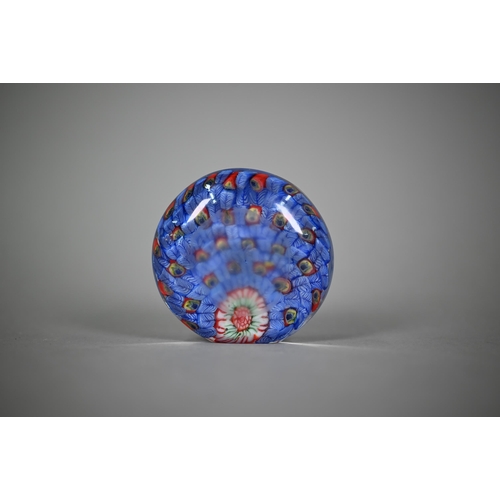 562 - A floral specimen paperweight with 'J' cane - possibly John Deacons, 7.5 cm diam to/w two millefiori... 