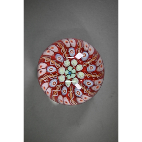 562 - A floral specimen paperweight with 'J' cane - possibly John Deacons, 7.5 cm diam to/w two millefiori... 