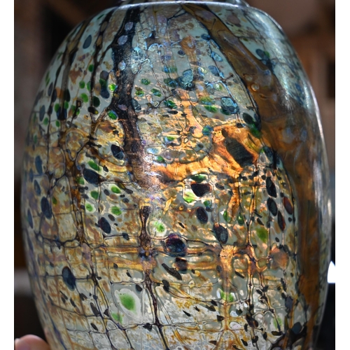 565 - Peter Layton (b 1937) - An iridescent glass ovoid vase with abstract streaked and hatched decoration... 