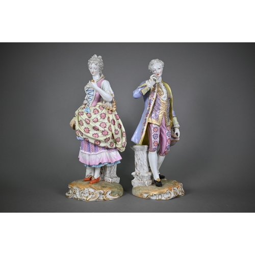 571 - A pair of late 19th century German porcelain figures of an elegant 18th century couple, underglaze b... 