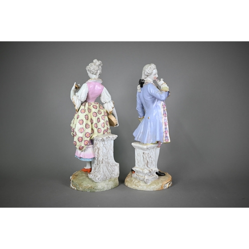 571 - A pair of late 19th century German porcelain figures of an elegant 18th century couple, underglaze b... 