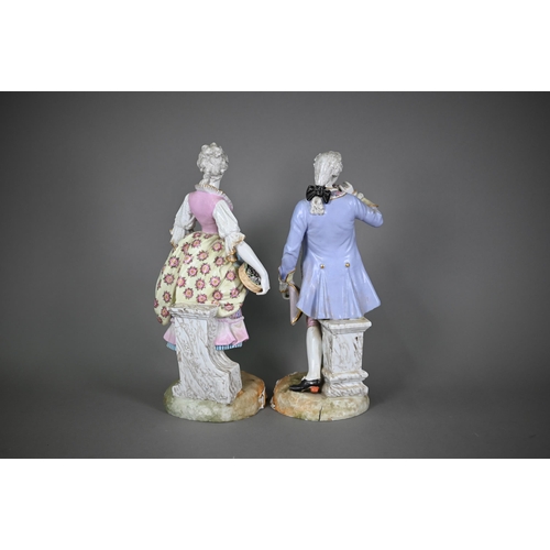 571 - A pair of late 19th century German porcelain figures of an elegant 18th century couple, underglaze b... 