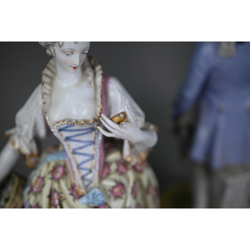 571 - A pair of late 19th century German porcelain figures of an elegant 18th century couple, underglaze b... 