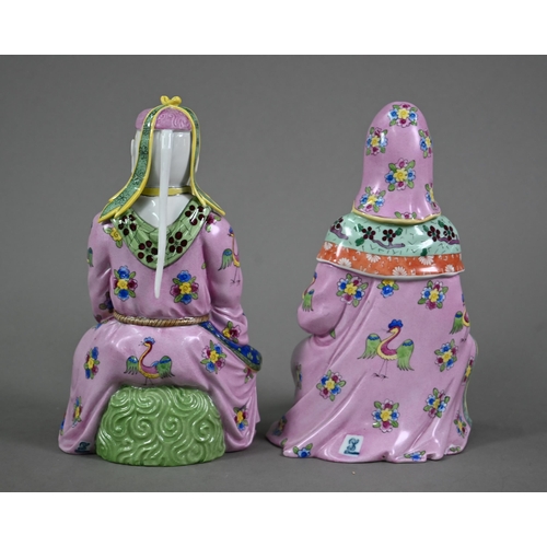 574 - A pair of Dresden figures of a Chinese couple in pink official's robes painted with flowers and bird... 