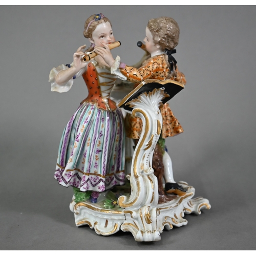 577 - A Meissen porcelain group of two 18th century children, fingering each others flutes, after a model ... 