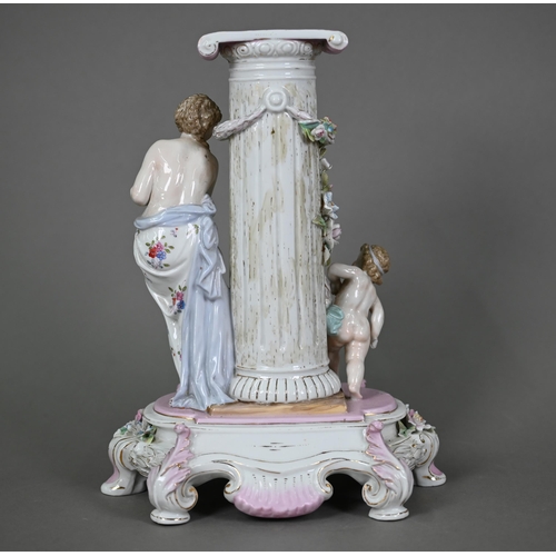 578 - A German porcelain pedestal, modelled with a shy maiden playing hide and seek with Cupid around a fl... 