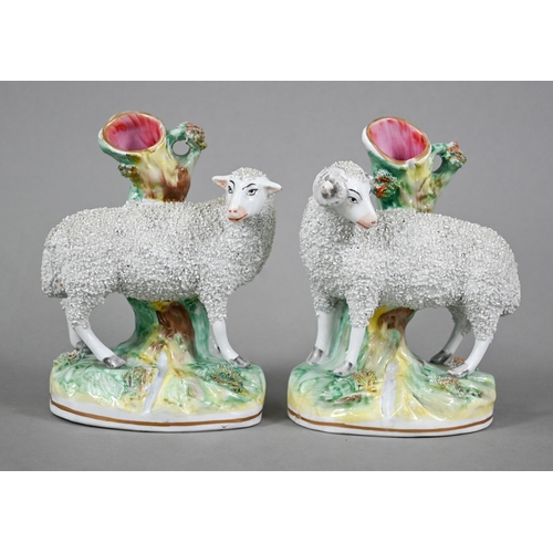 582 - A pair of 19th century Staffordshire pottery spill-vase figures mounted with frit-decorated Ewe and ... 