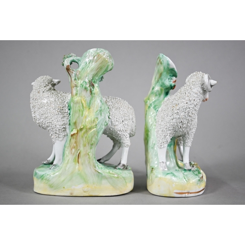 582 - A pair of 19th century Staffordshire pottery spill-vase figures mounted with frit-decorated Ewe and ... 