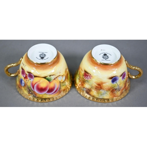 597 - A pair of Royal Worcester cabinet tea cups and saucers, painted with fruit still lives, signed S. Wo... 