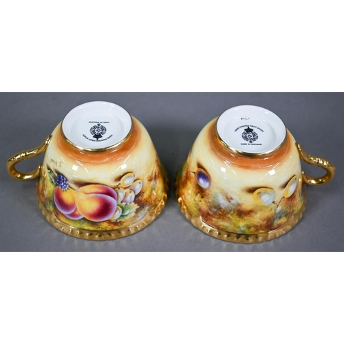 597 - A pair of Royal Worcester cabinet tea cups and saucers, painted with fruit still lives, signed S. Wo... 