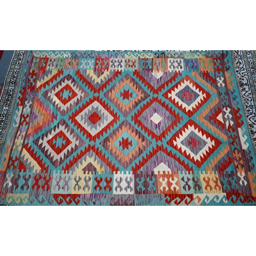 822 - An Anatolian kilim, the multi-coloured lozenge design on pale ground, 205 cm x 150 cm