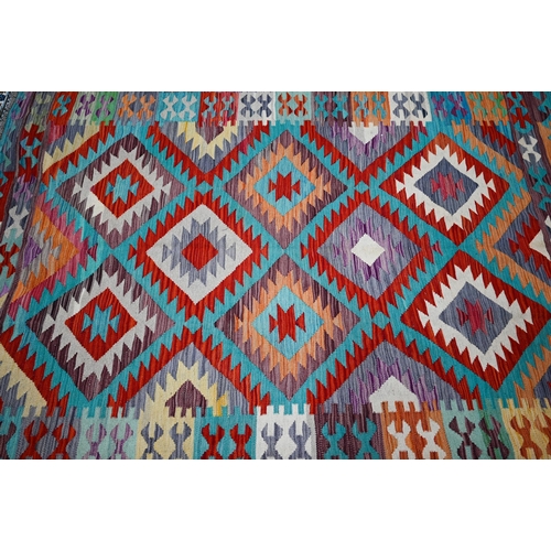 822 - An Anatolian kilim, the multi-coloured lozenge design on pale ground, 205 cm x 150 cm
