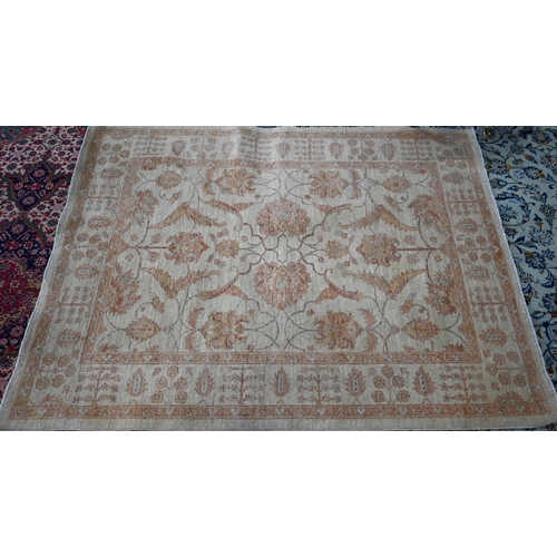827 - A contemporary Indian Agra carpet, the yelllow/ochre ground with muted floral design, 204 cm x 154 c... 
