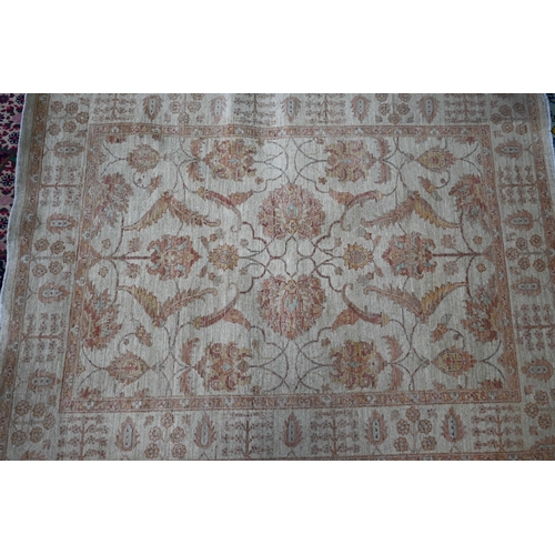827 - A contemporary Indian Agra carpet, the yelllow/ochre ground with muted floral design, 204 cm x 154 c... 