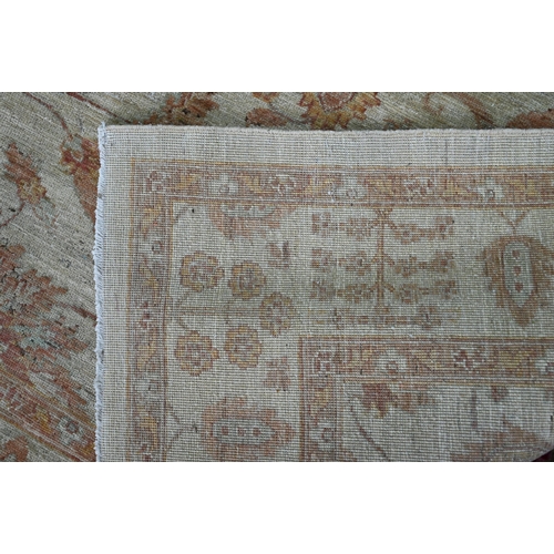 827 - A contemporary Indian Agra carpet, the yelllow/ochre ground with muted floral design, 204 cm x 154 c... 