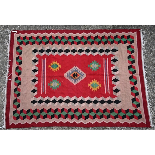 838 - An old Turkish Kelim, the red ground with geometric designs, 277 cm x 196 cm