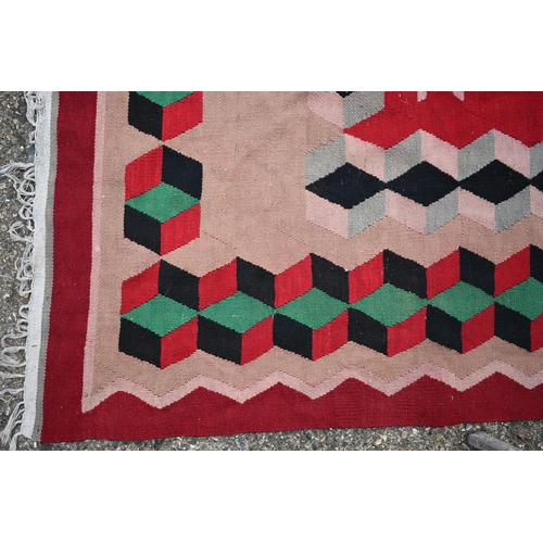 838 - An old Turkish Kelim, the red ground with geometric designs, 277 cm x 196 cm