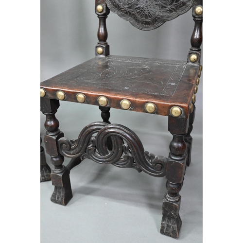 852 - A pair of late 19th century walnut framed hall chairs, the studded brass leather seat and back in to... 