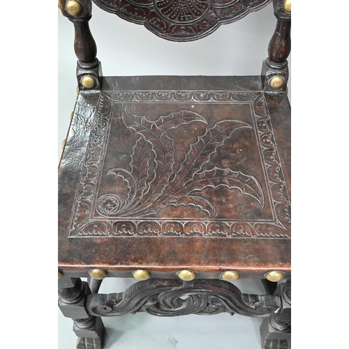 852 - A pair of late 19th century walnut framed hall chairs, the studded brass leather seat and back in to... 