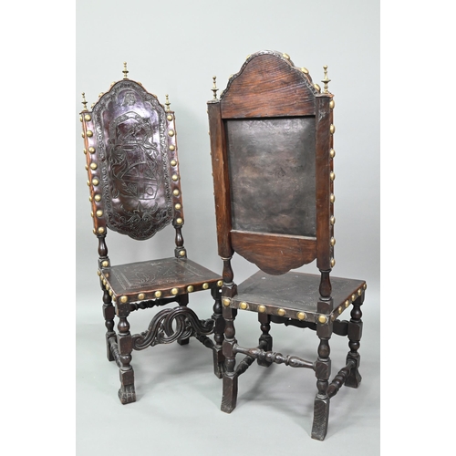 852 - A pair of late 19th century walnut framed hall chairs, the studded brass leather seat and back in to... 