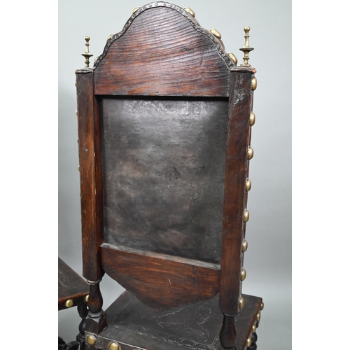 852 - A pair of late 19th century walnut framed hall chairs, the studded brass leather seat and back in to... 