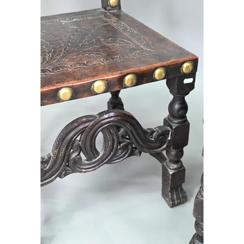 852 - A pair of late 19th century walnut framed hall chairs, the studded brass leather seat and back in to... 