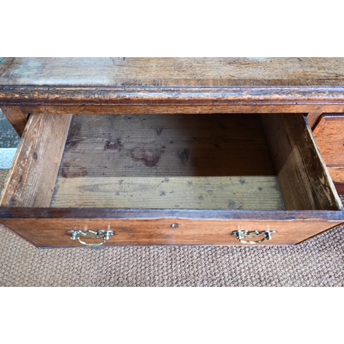 859 - A late 17th century oak three drawer low dresser, raised on square section legs, later brass handles... 