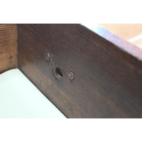 859 - A late 17th century oak three drawer low dresser, raised on square section legs, later brass handles... 