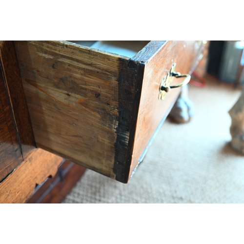 859 - A late 17th century oak three drawer low dresser, raised on square section legs, later brass handles... 