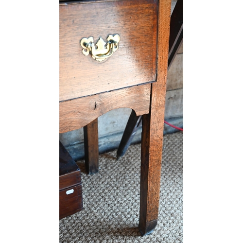 859 - A late 17th century oak three drawer low dresser, raised on square section legs, later brass handles... 