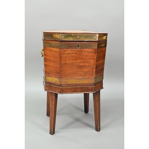 874 - A George III brass bound mahogany wine cooler of octagonal form, with internal zinc liner, raised on... 