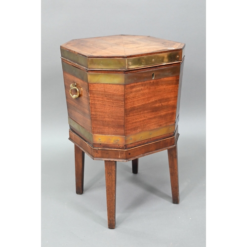 874 - A George III brass bound mahogany wine cooler of octagonal form, with internal zinc liner, raised on... 