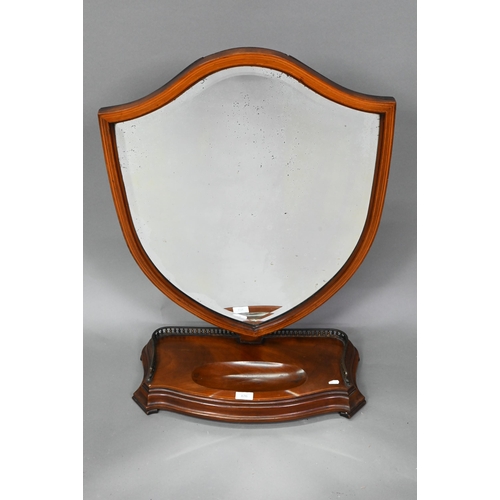 876 - A large Victorian Sheraton Revival mahogany framed adjustable shield shaped toilet mirror, with beve... 